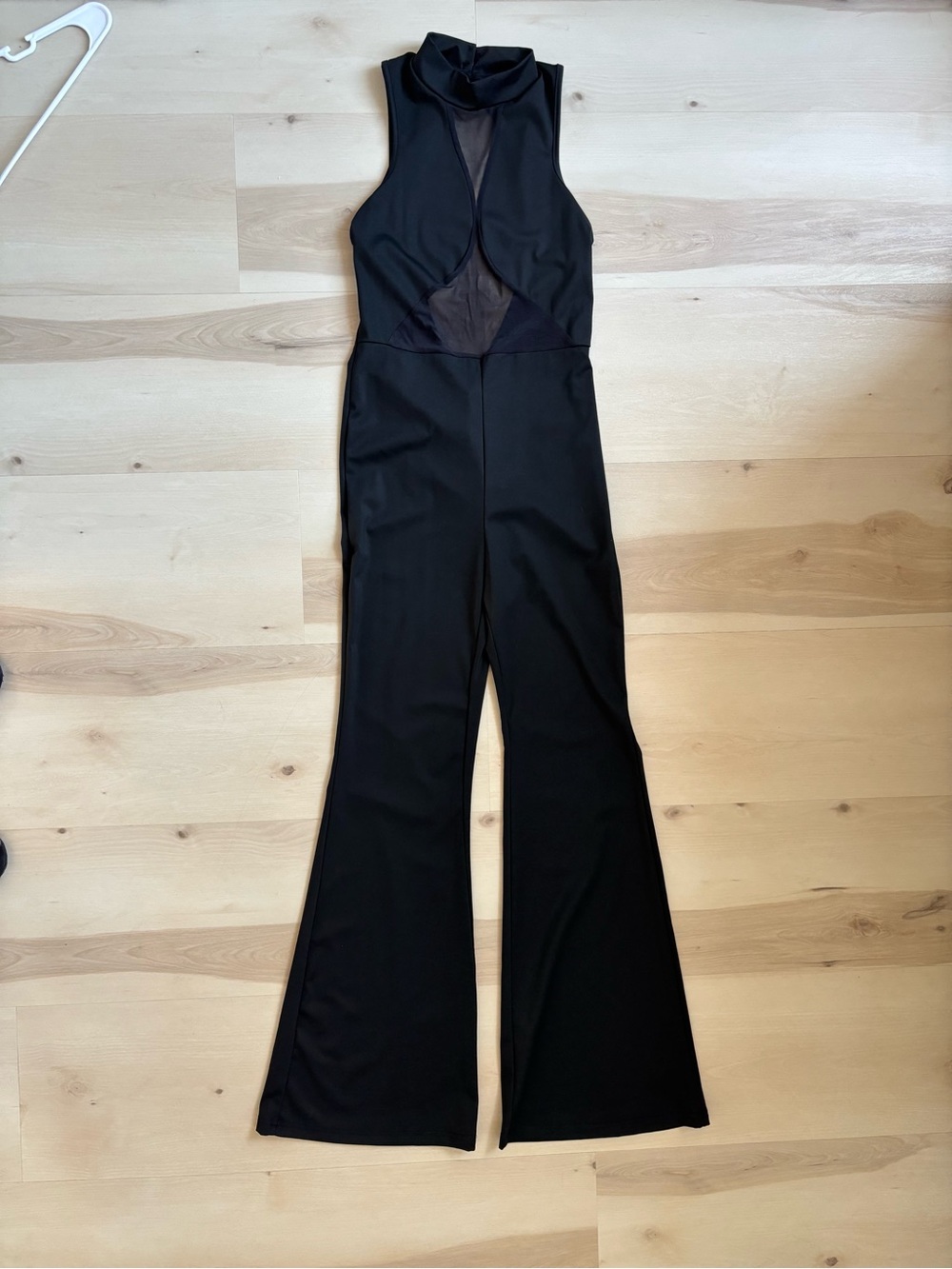 Sleek Black Sleeveless Mock-Neck Jumpsuit with Sheer Front Panel